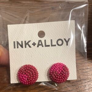 Magenta and maroon beaded earrings.
